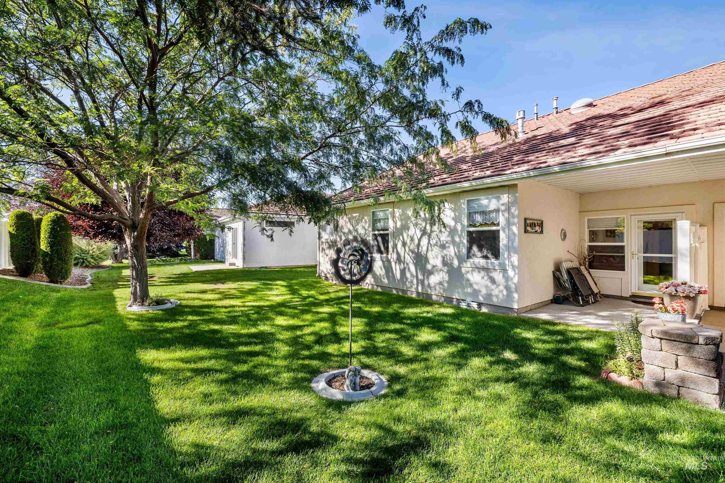 View of green lawn featuring a patio