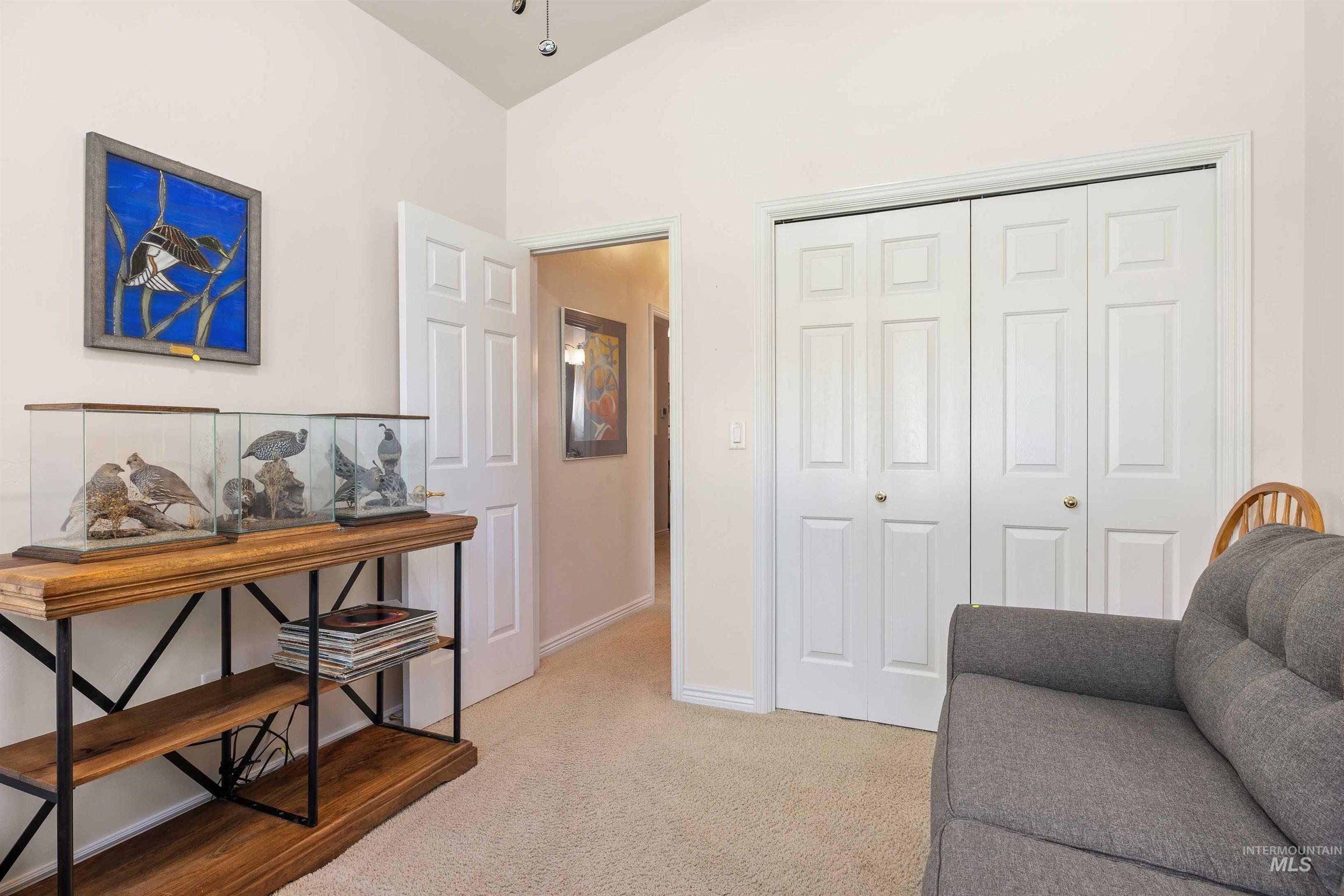 Sitting room with light colored carpet and baseboards