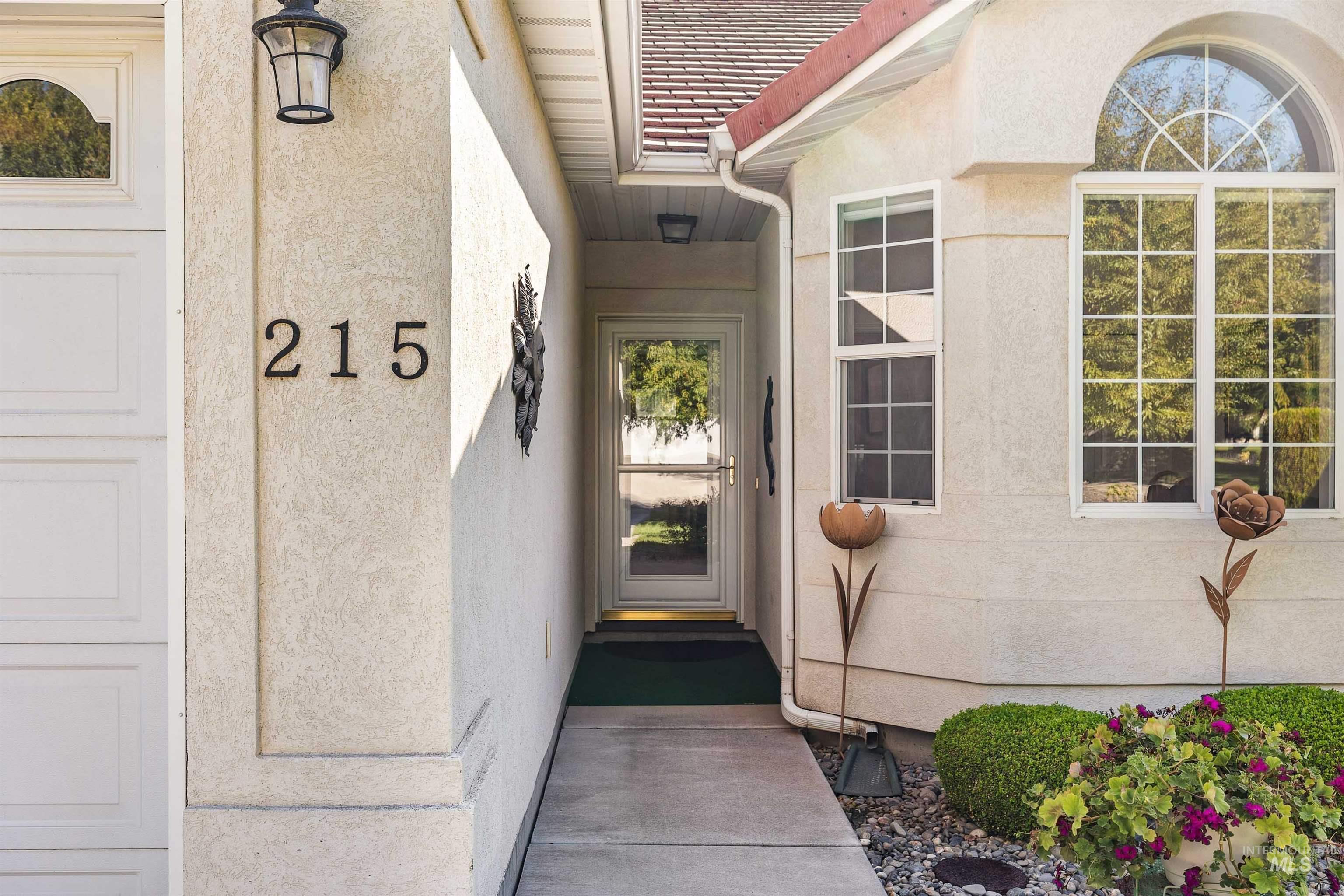 Doorway to property featuring stucco siding