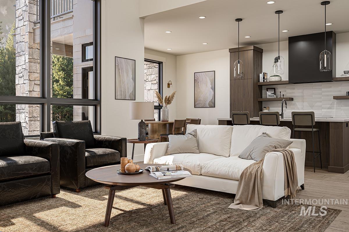 Living room featuring healthy amount of natural light, recessed lighting, and light wood-style floors