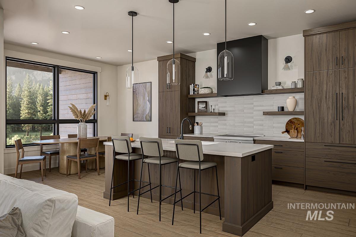 Kitchen with modern cabinets, open shelves, a breakfast bar area, backsplash, and recessed lighting