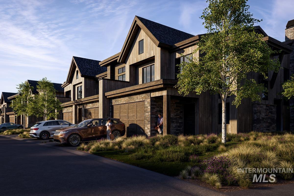 View of front of home with stone siding, an attached garage, and roof with shingles