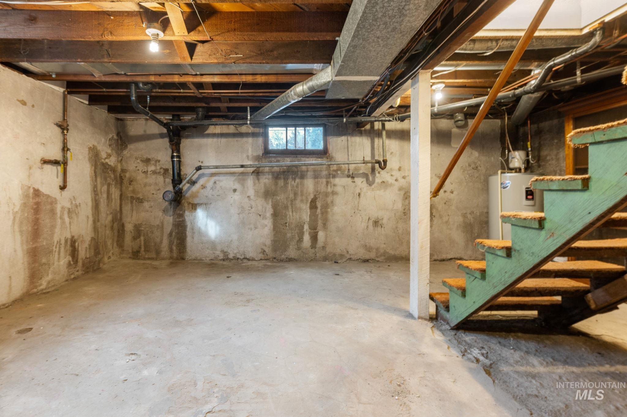 Basement with stairway and water heater