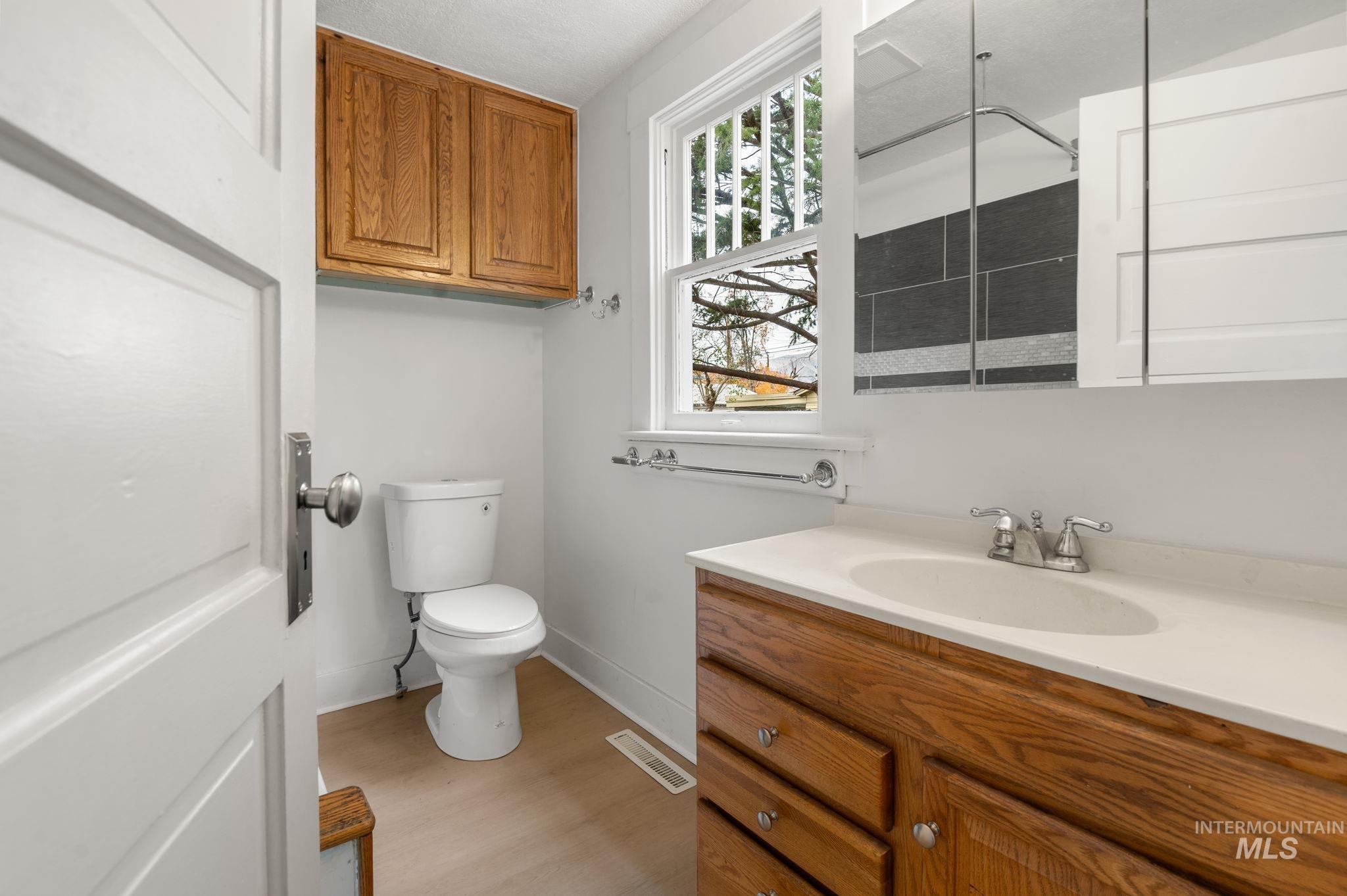 Bathroom featuring light wood finished floors and vanity
