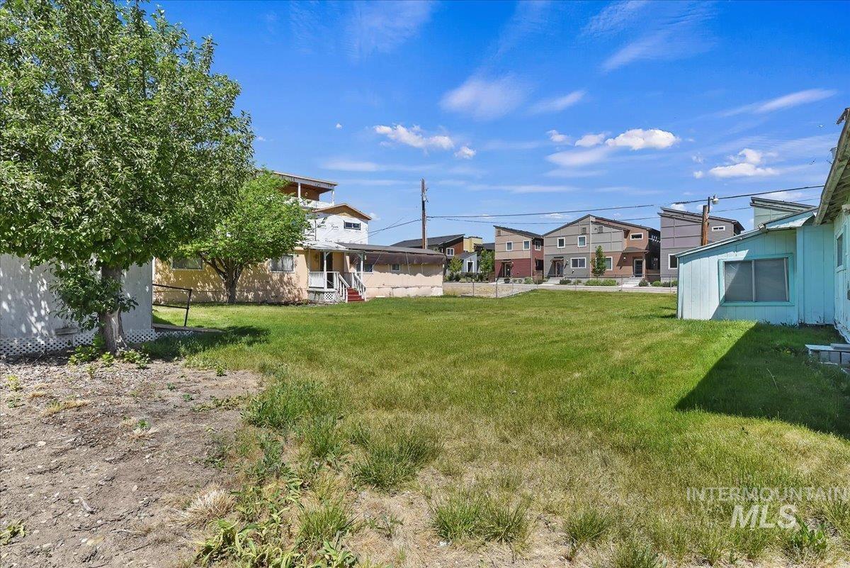 Expansive lot featuring a large grassy area and mature trees