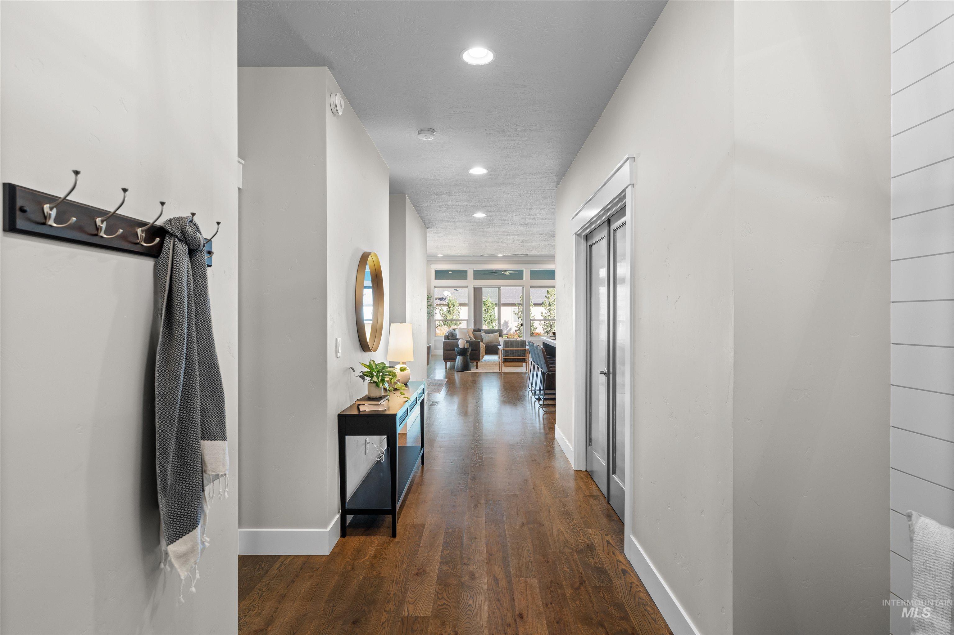 Hallway featuring recessed lighting and dark wood-style flooring