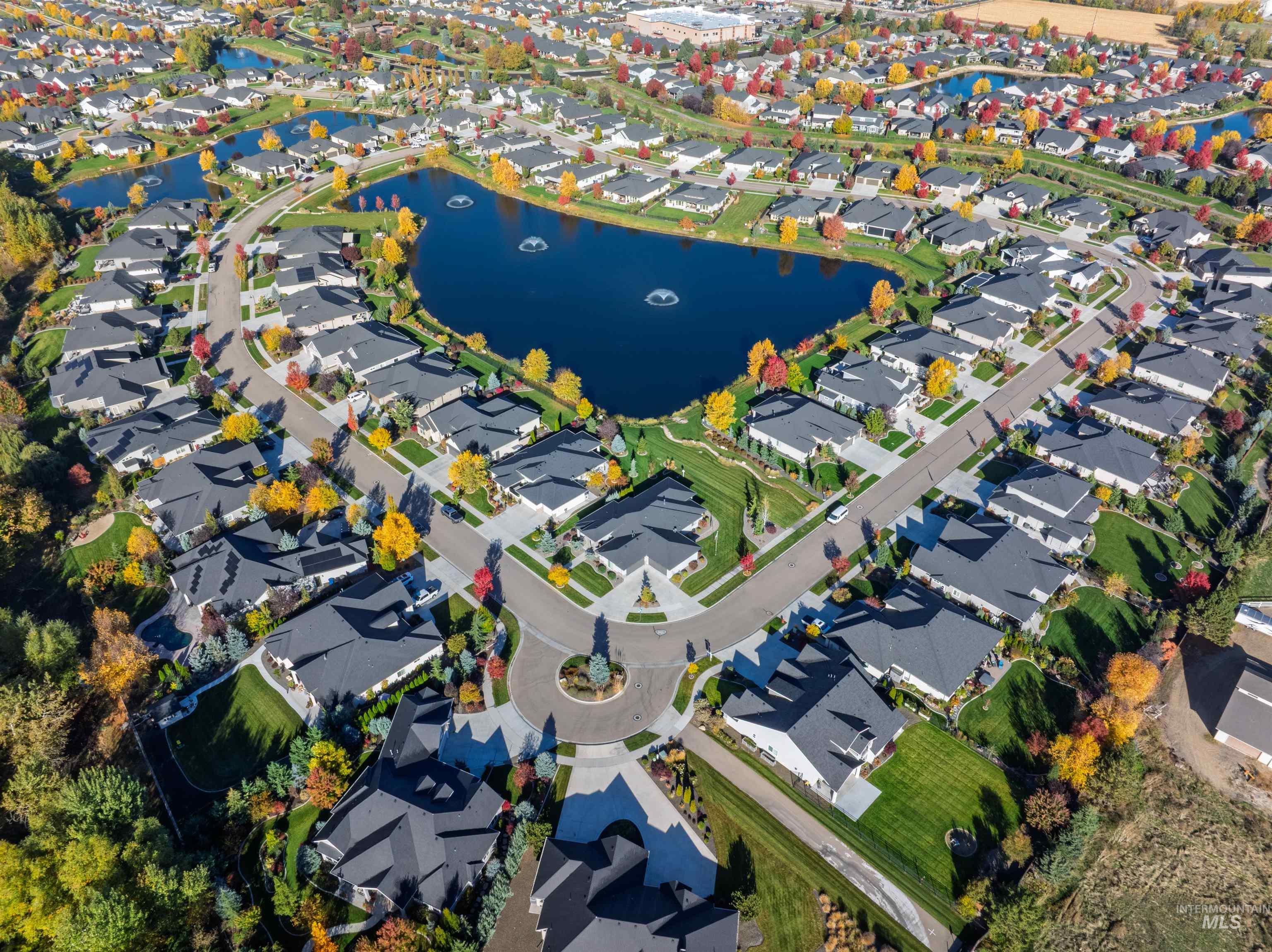 Aerial overview of property's location featuring a nearby body of water and nearby suburban area