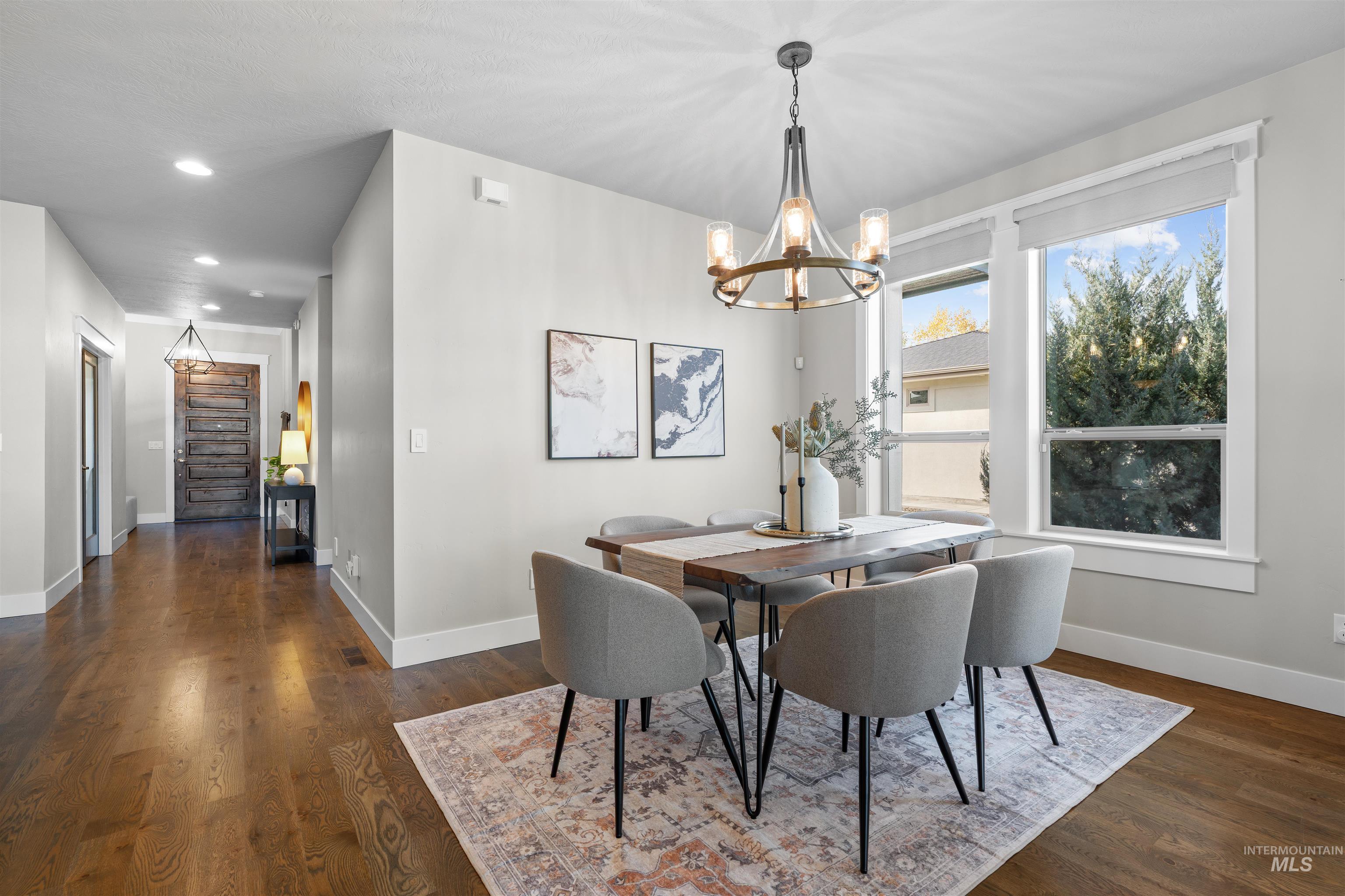 Dining room featuring dark wood finished floors and hanging lights