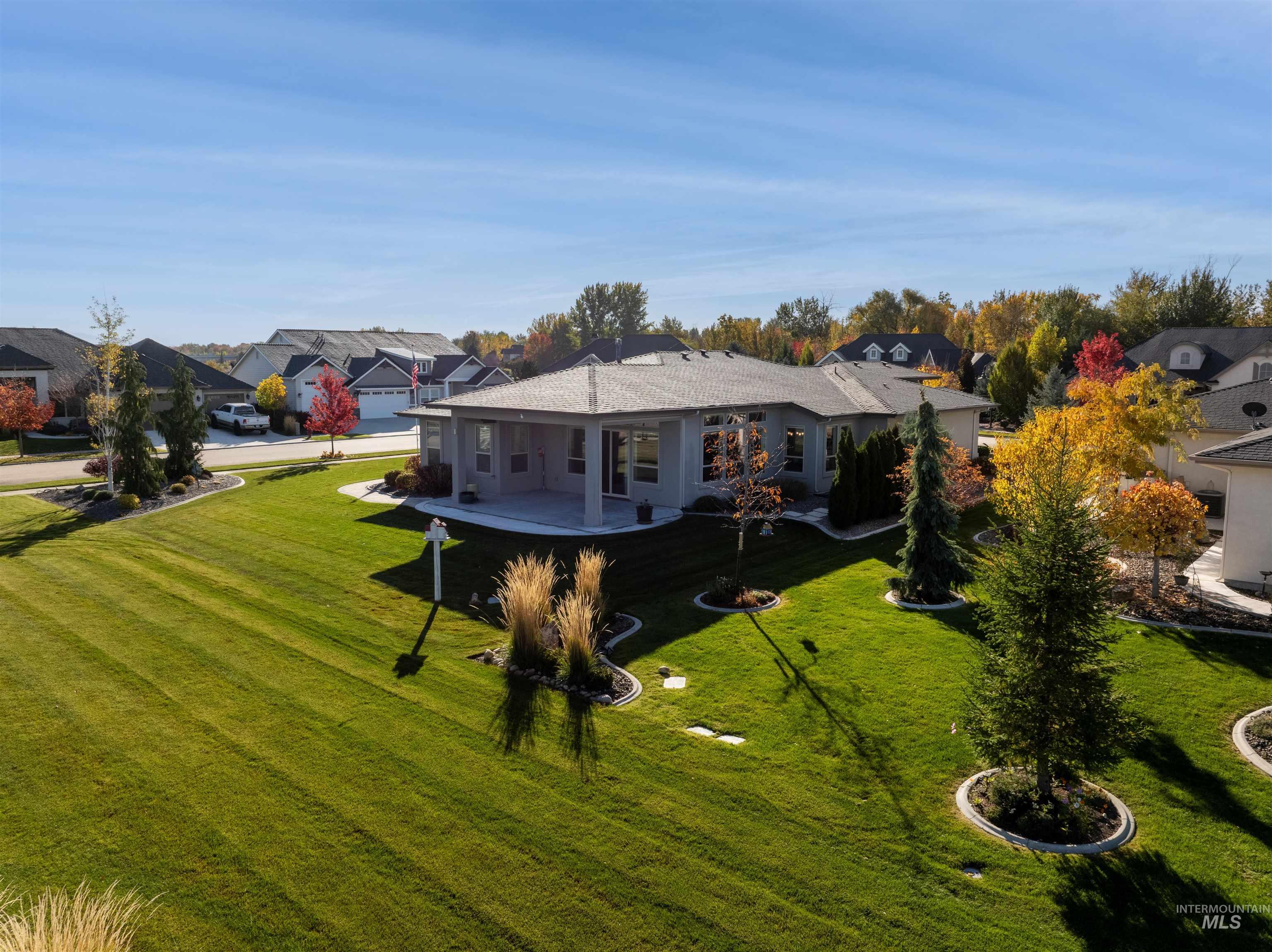 Rear view of house featuring a yard and a residential view
