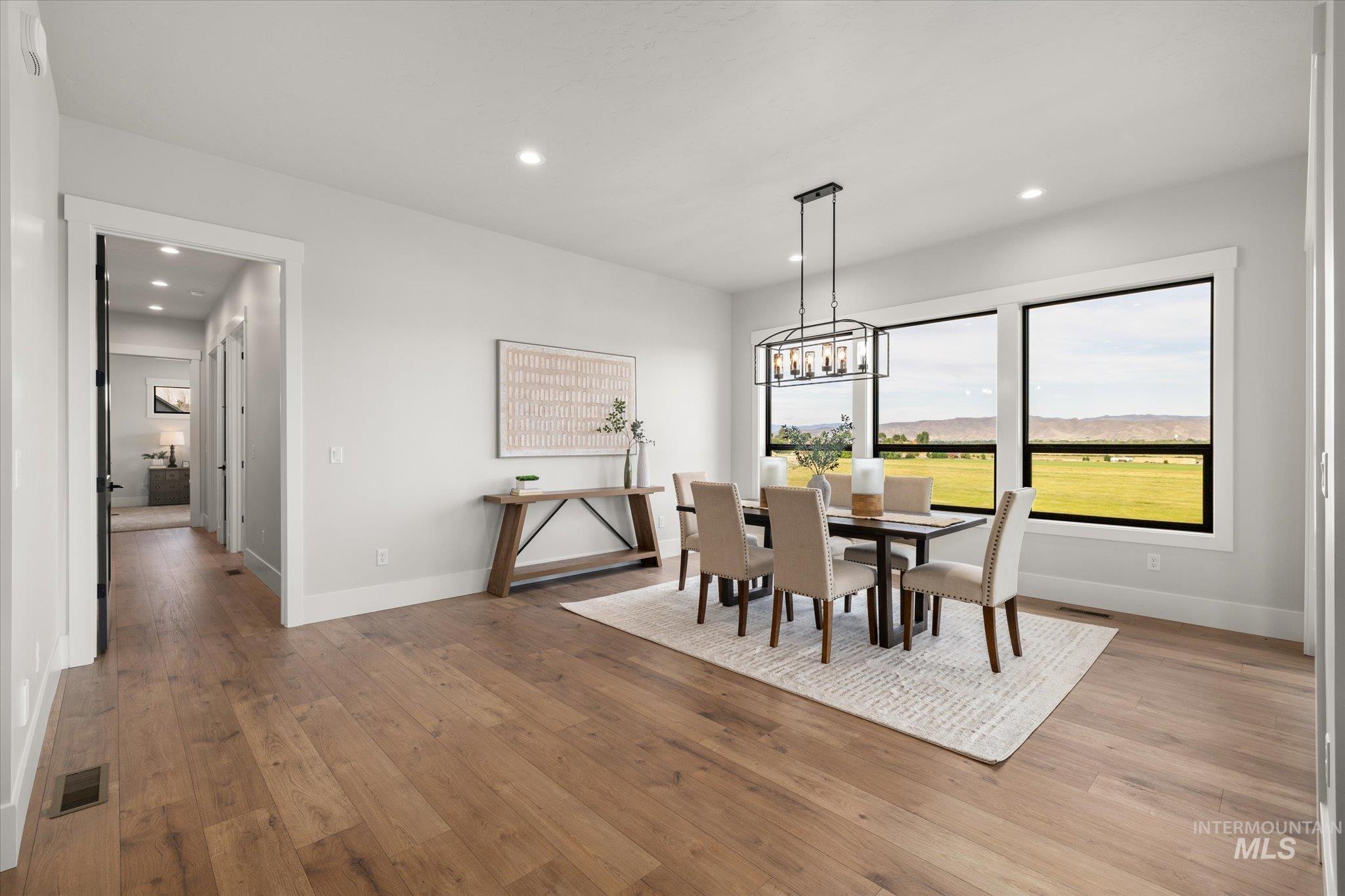 Dining area featuring light wood finished floors, recessed lighting, a chandelier, and a mountain view