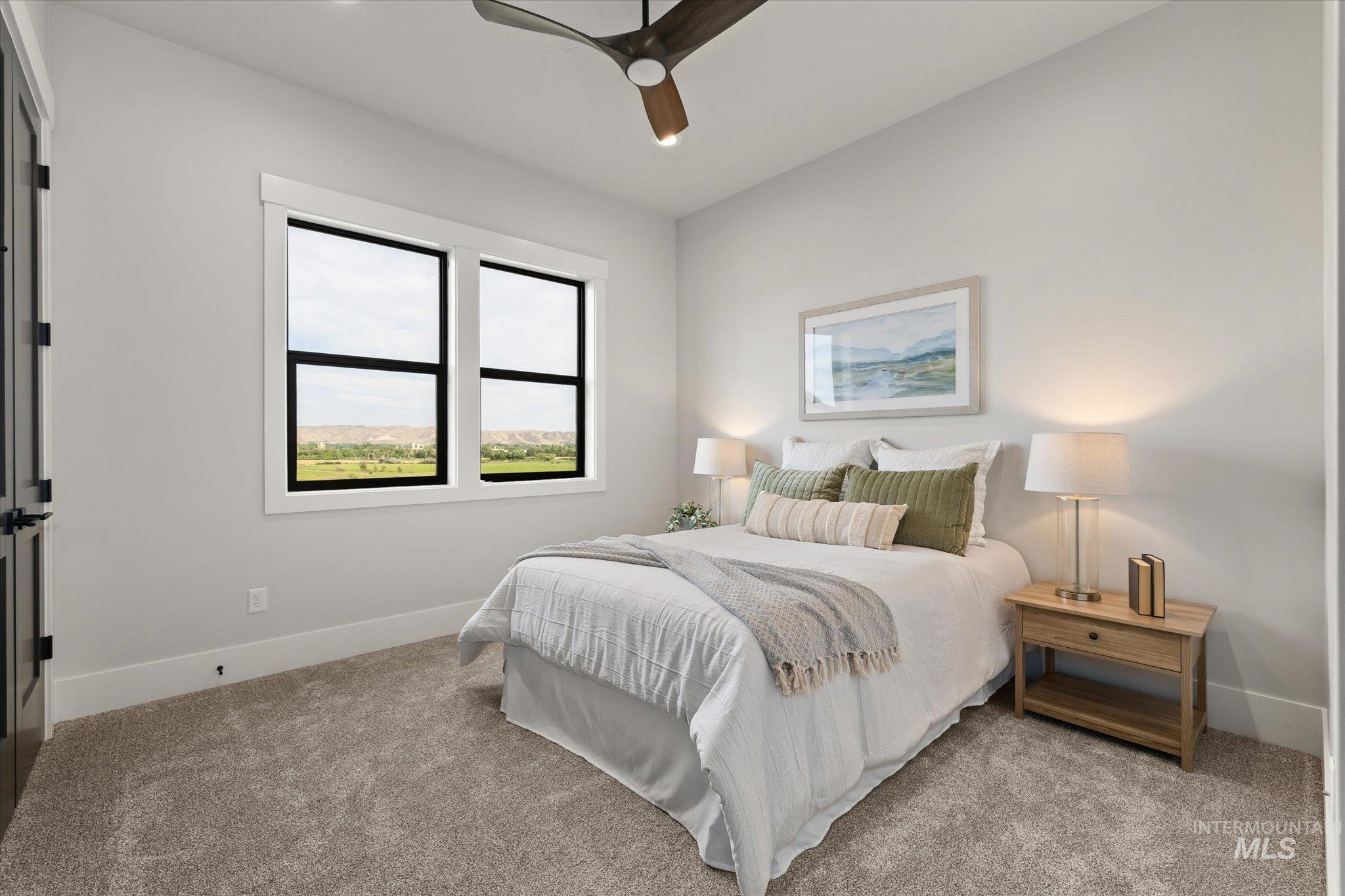 Carpeted bedroom with baseboards and ceiling fan