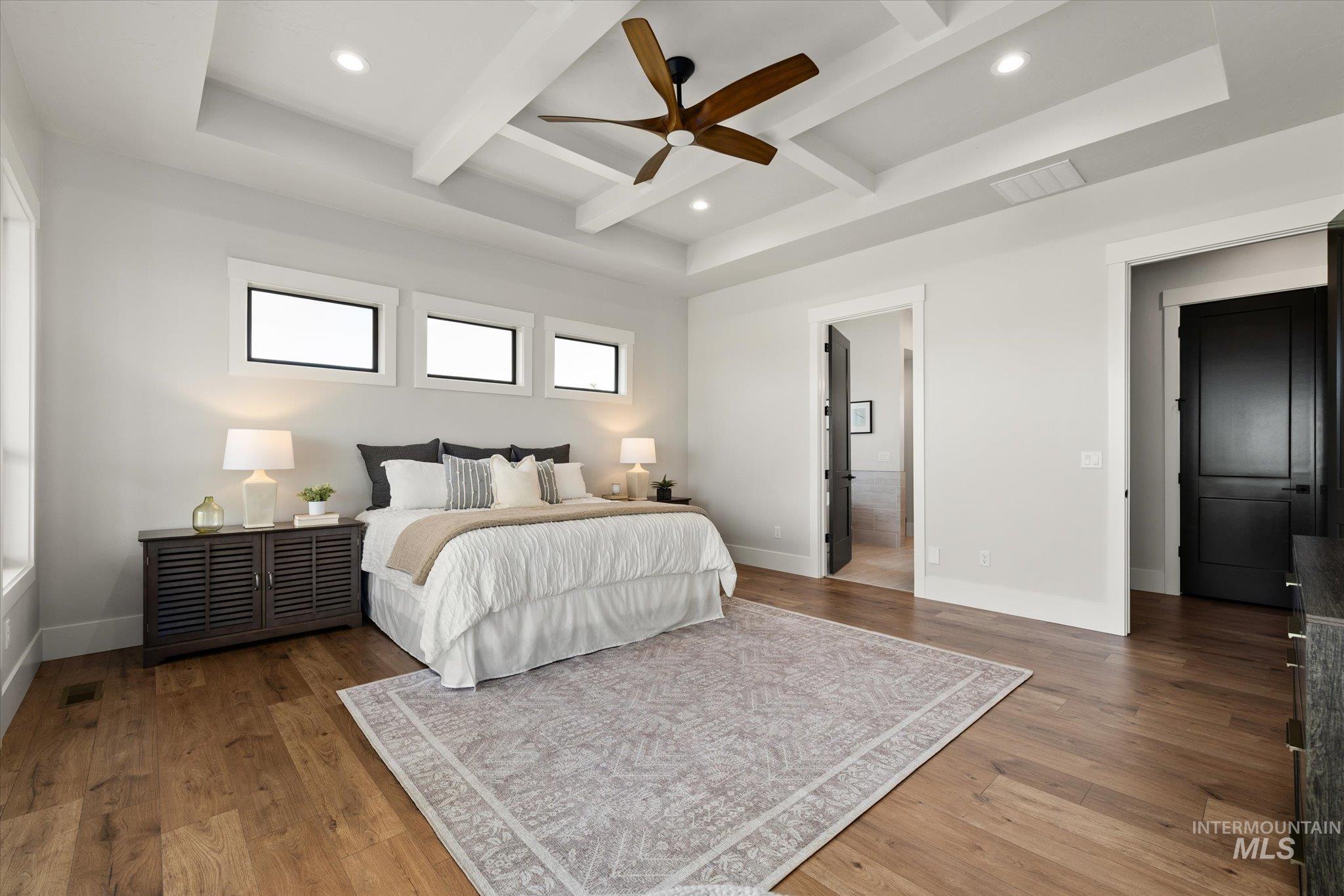 Bedroom featuring beamed ceiling, wood finished floors, a ceiling fan, coffered ceiling, and recessed lighting