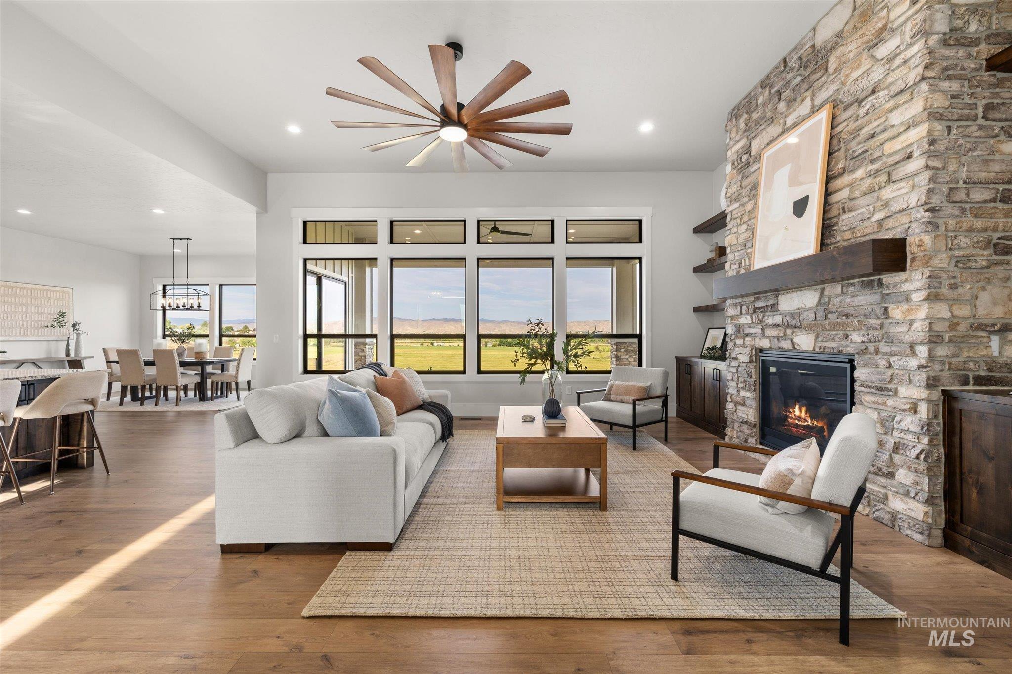 Living area featuring wood finished floors, a fireplace, and recessed lighting