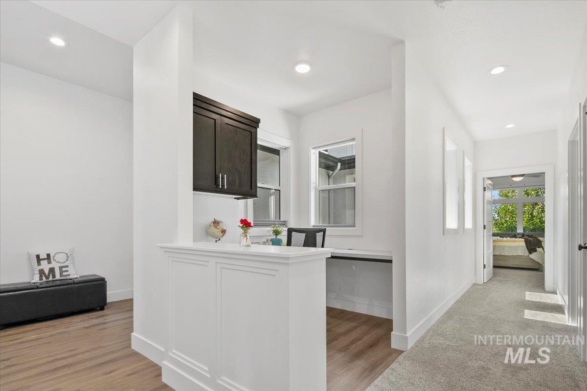 Hall with recessed lighting and light wood-type flooring