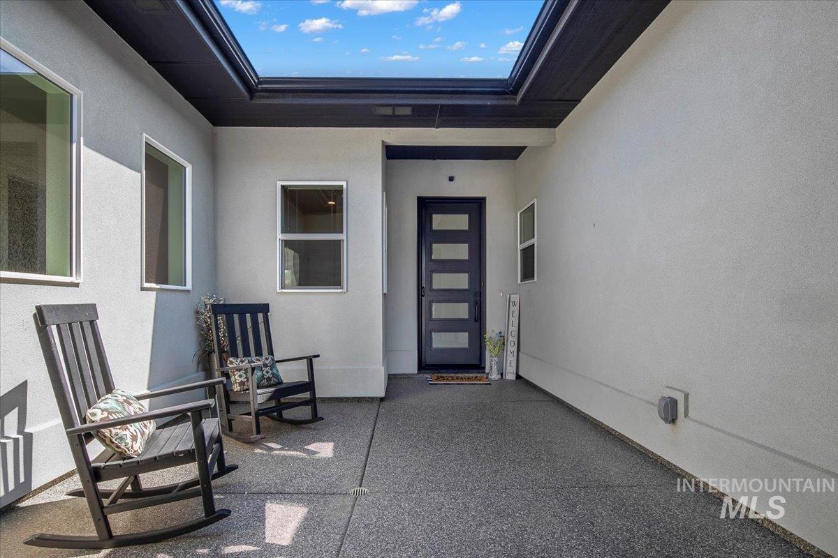 Entrance to property featuring stucco siding