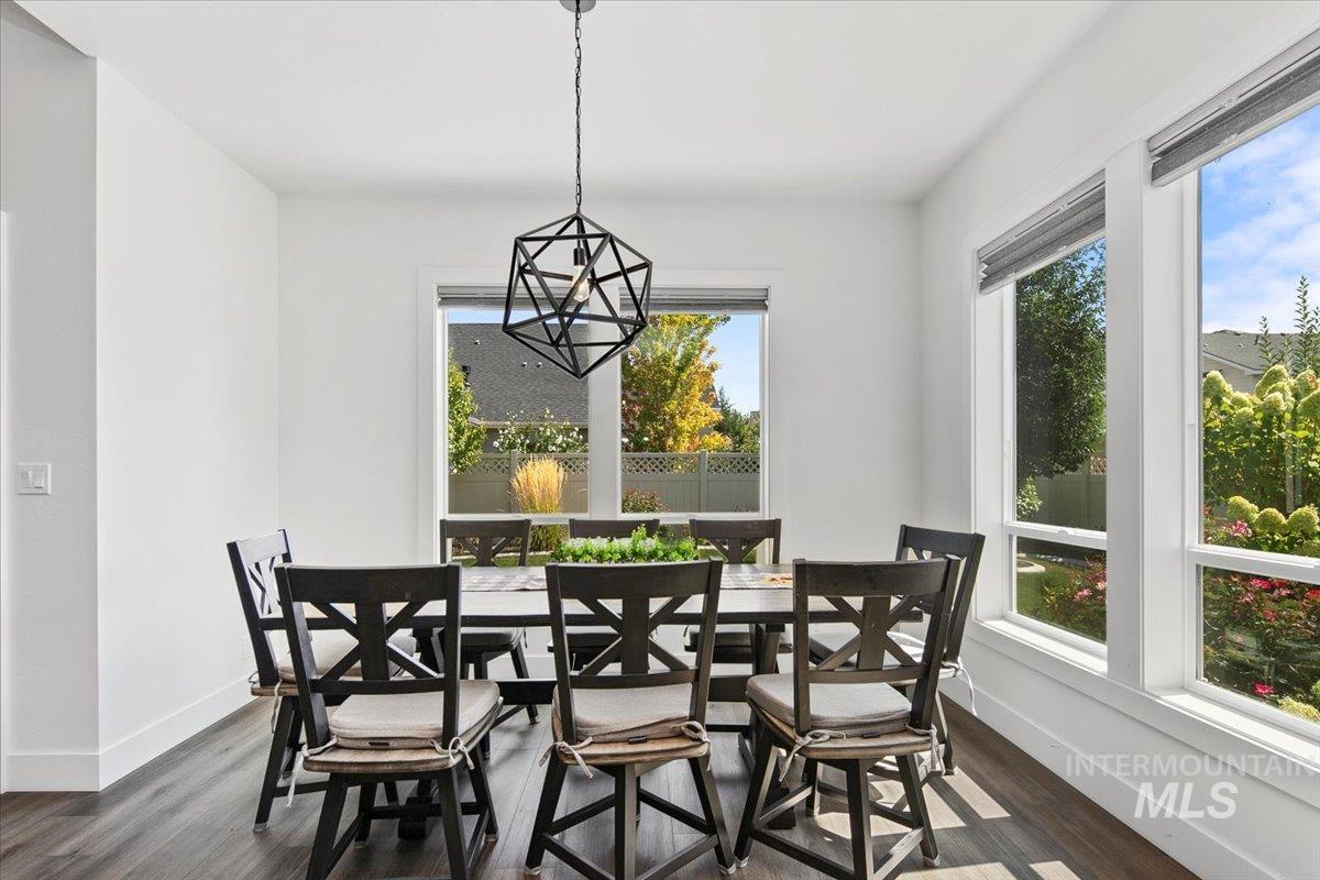 Dining room with healthy amount of natural light and dark wood finished floors
