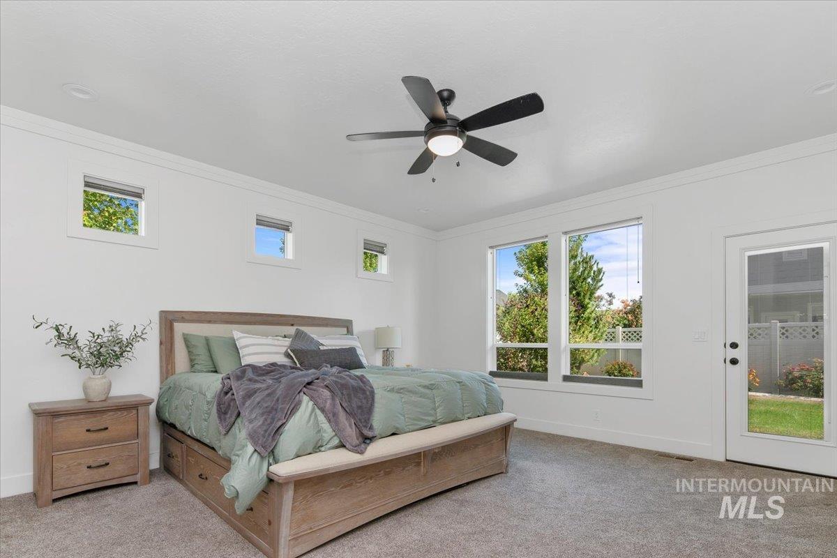 Bedroom with crown molding, carpet flooring, a ceiling fan, and access to outside