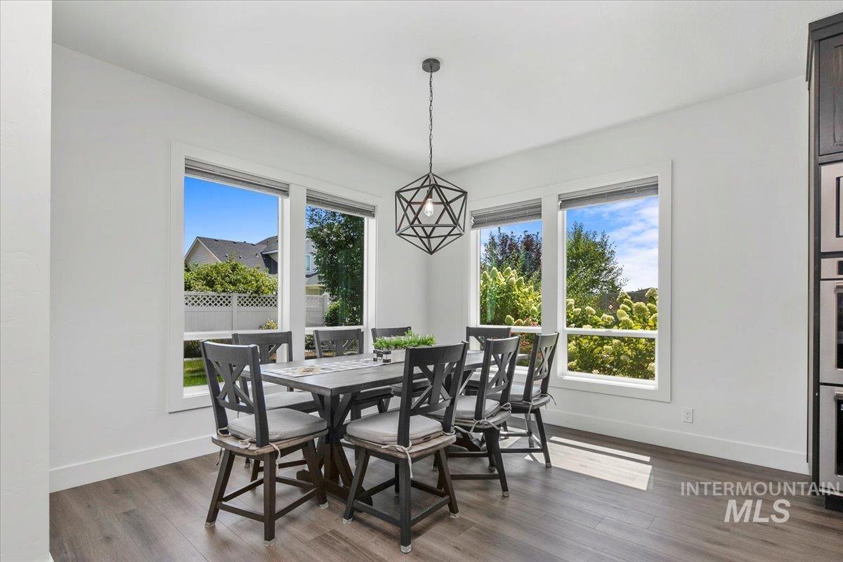 Dining space with dark wood-style flooring