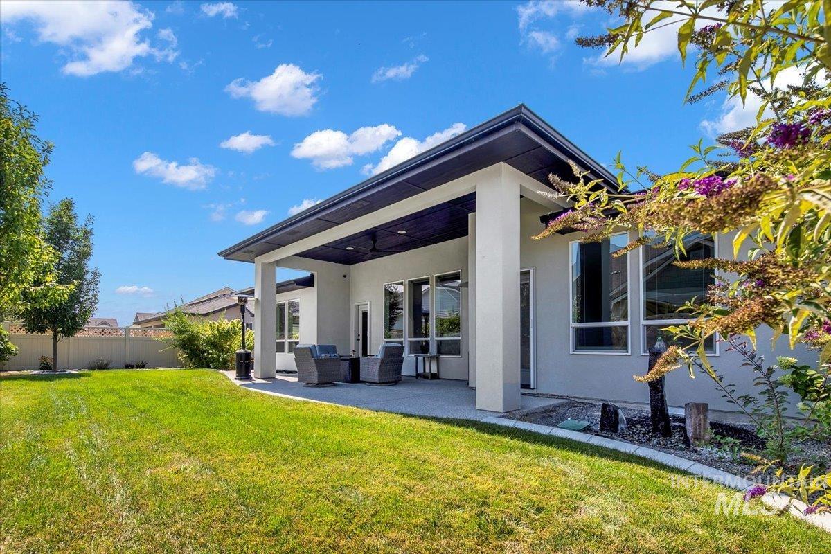Back of house featuring stucco siding, a patio area, and outdoor lounge area