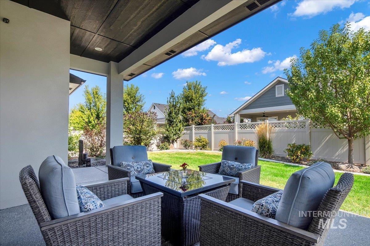 Fenced backyard featuring an outdoor living space and a patio area