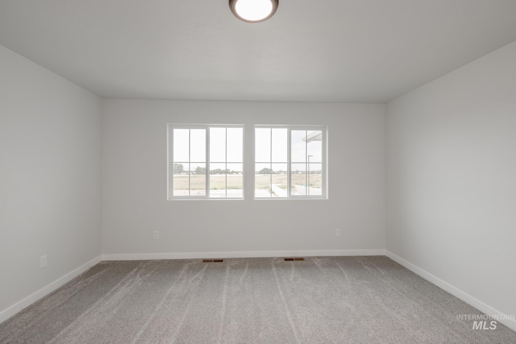 Unfurnished room with light carpet and baseboards