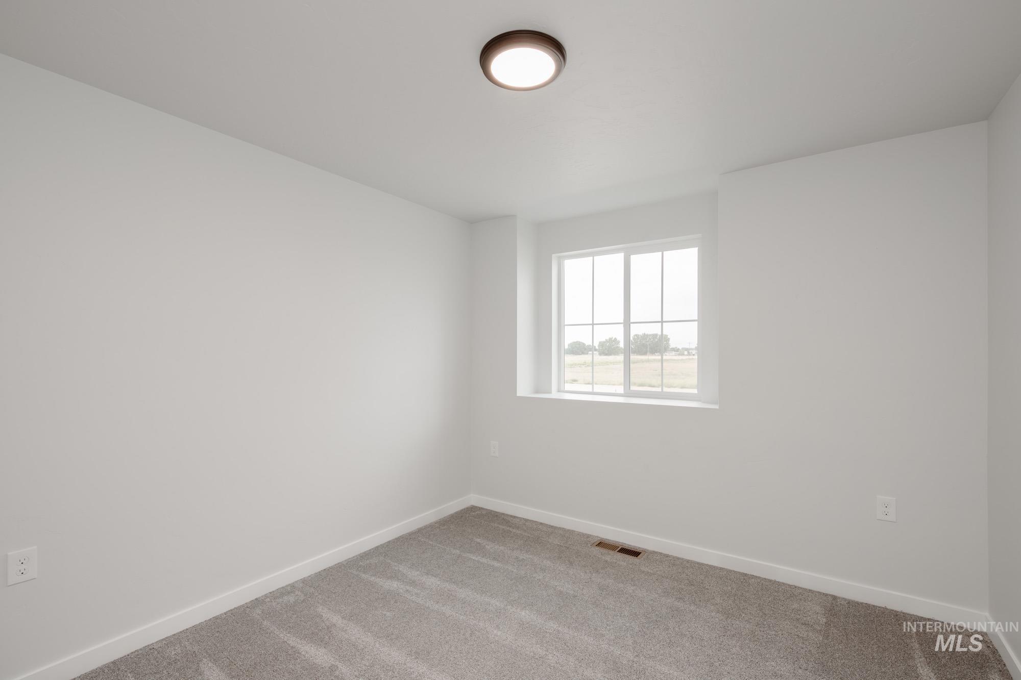 Spare room with carpet flooring and baseboards