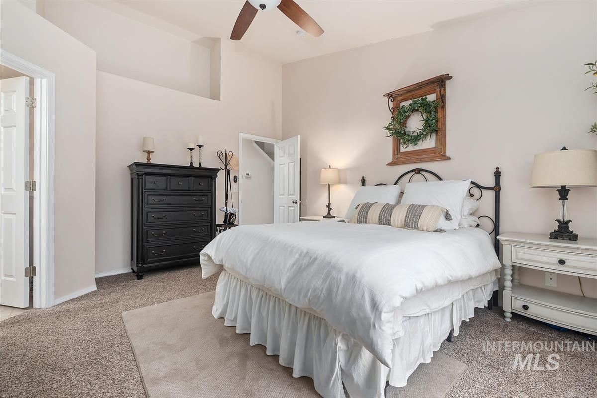 Bedroom with light colored carpet and ceiling fan