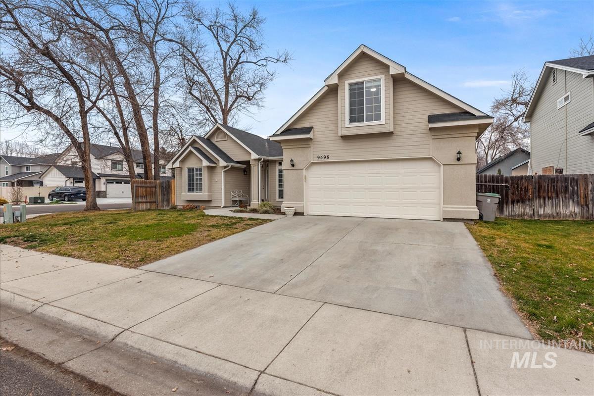 Traditional home featuring concrete driveway and an attached garage
