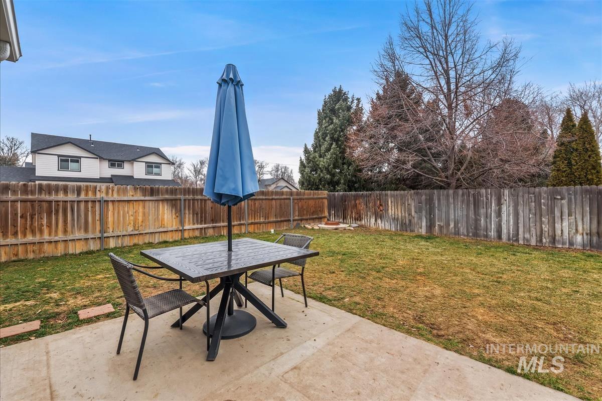 Fenced backyard with a patio area and outdoor dining area