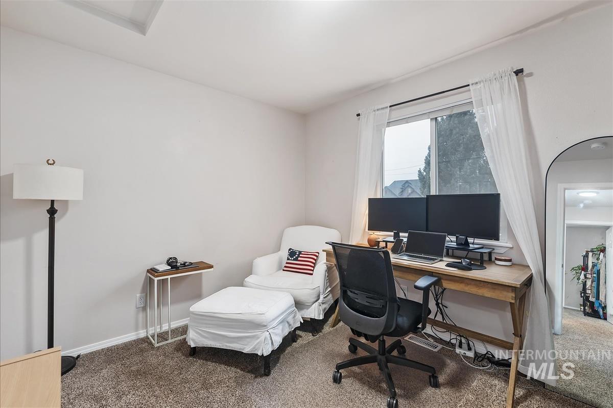 Carpeted office space with baseboards