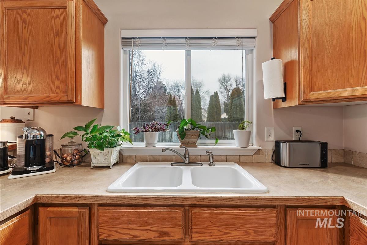 Kitchen with light countertops and brown cabinetry