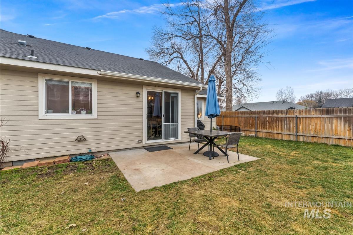 Back of house featuring a patio and a shingled roof