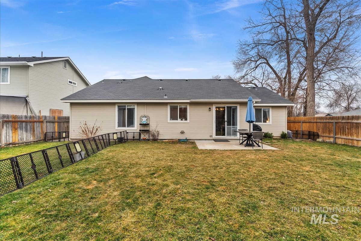Rear view of house with a patio and a fenced backyard