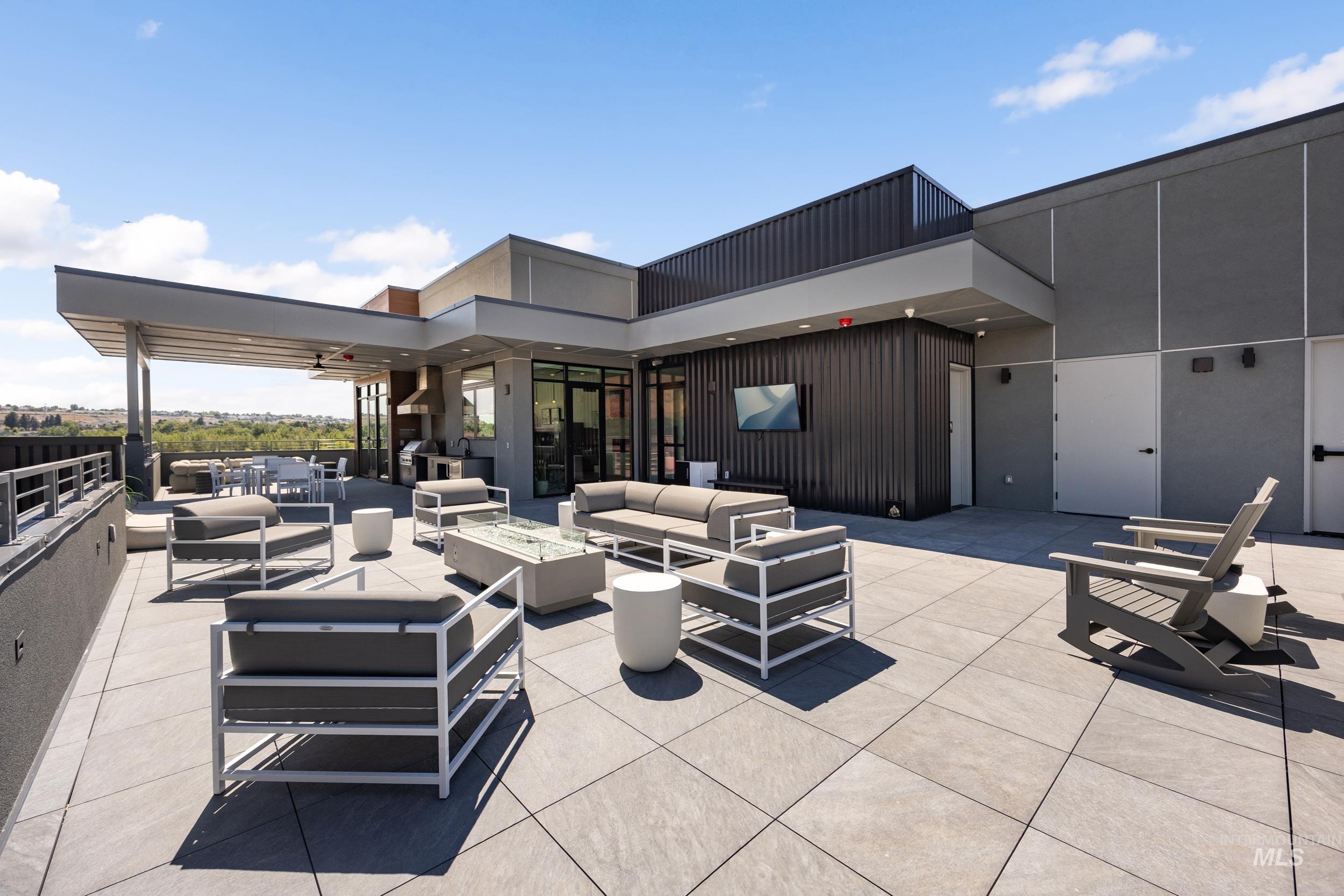 View of patio with an outdoor living space with a fire pit