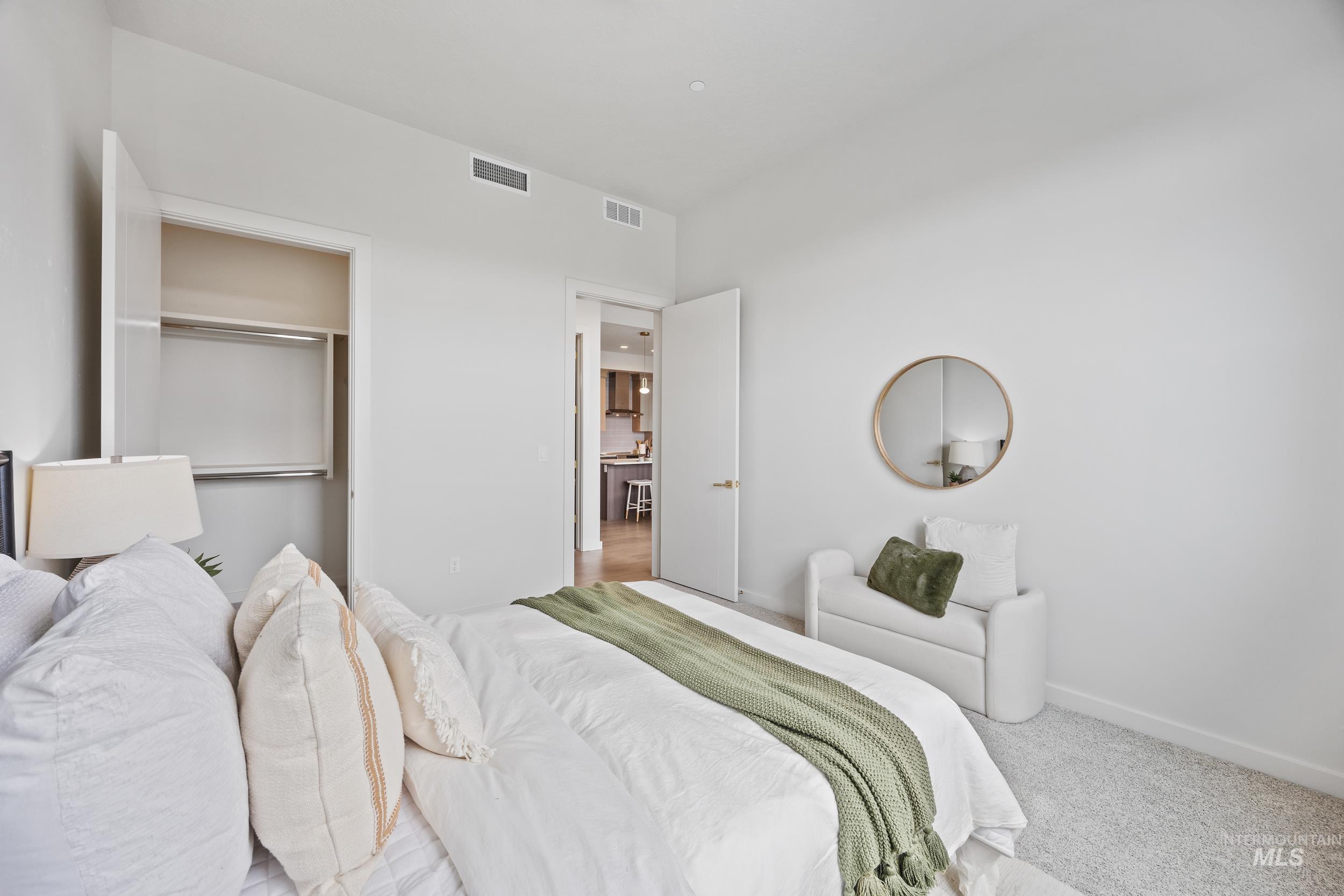 Carpeted bedroom featuring baseboards and a closet