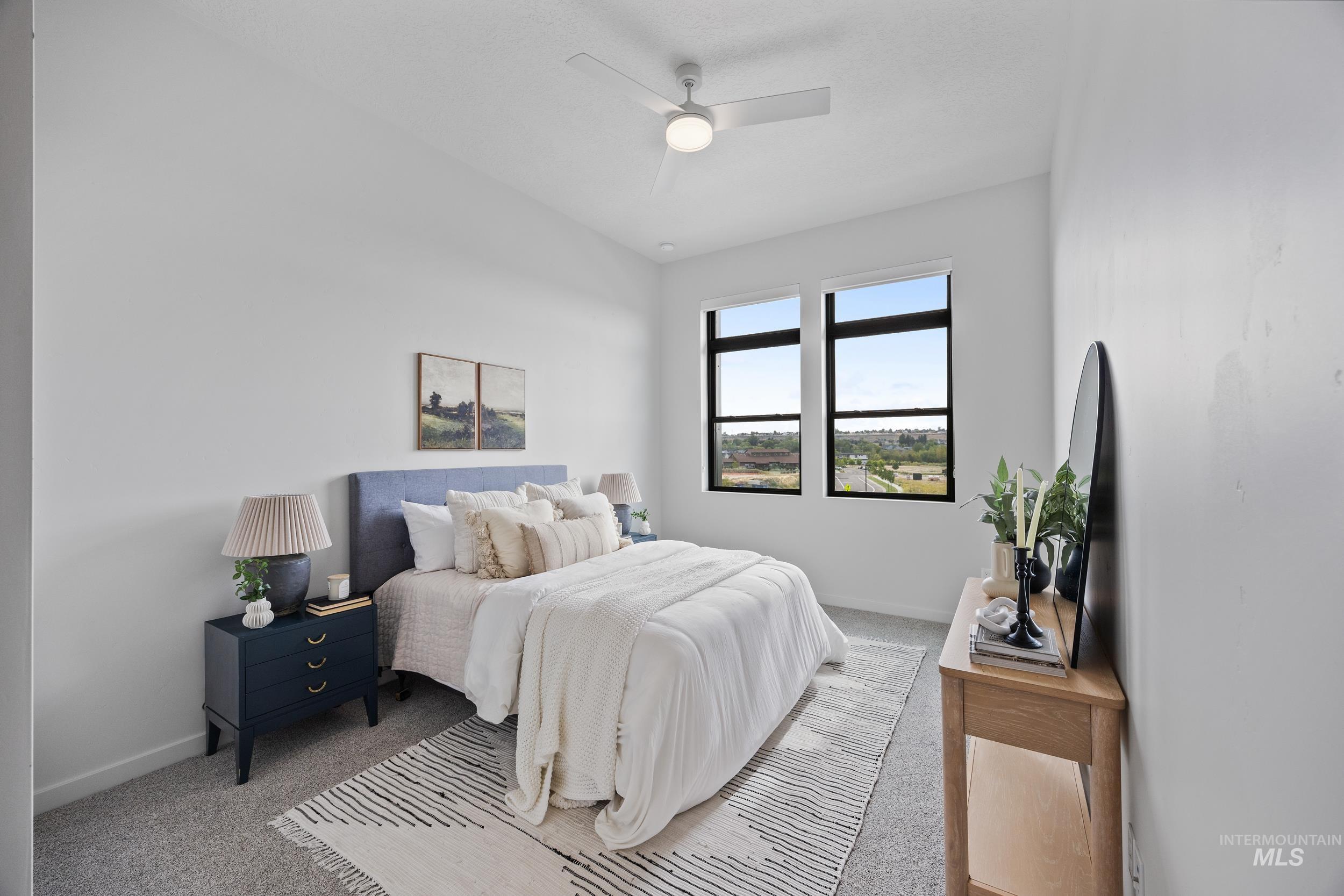 Carpeted bedroom featuring baseboards and ceiling fan