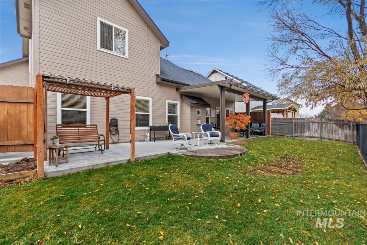 Rear view of house with a fenced backyard, a patio, and a pergola