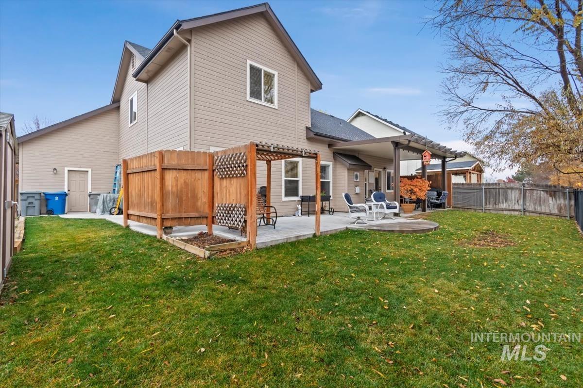 Rear view of house with a patio and a fenced backyard