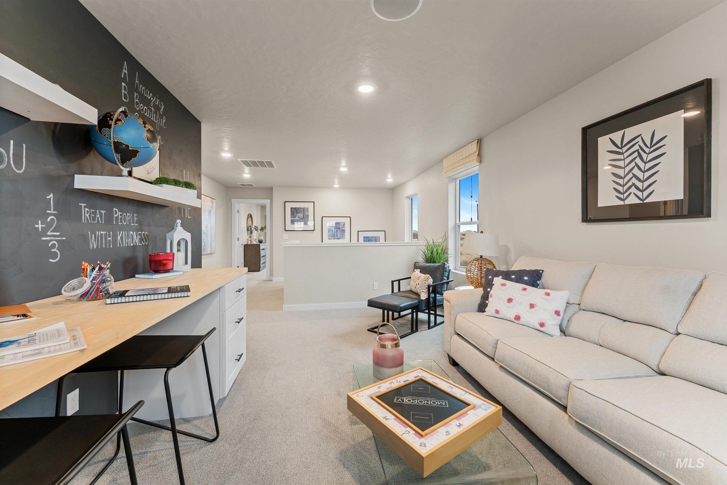 Living room with light colored carpet and baseboards