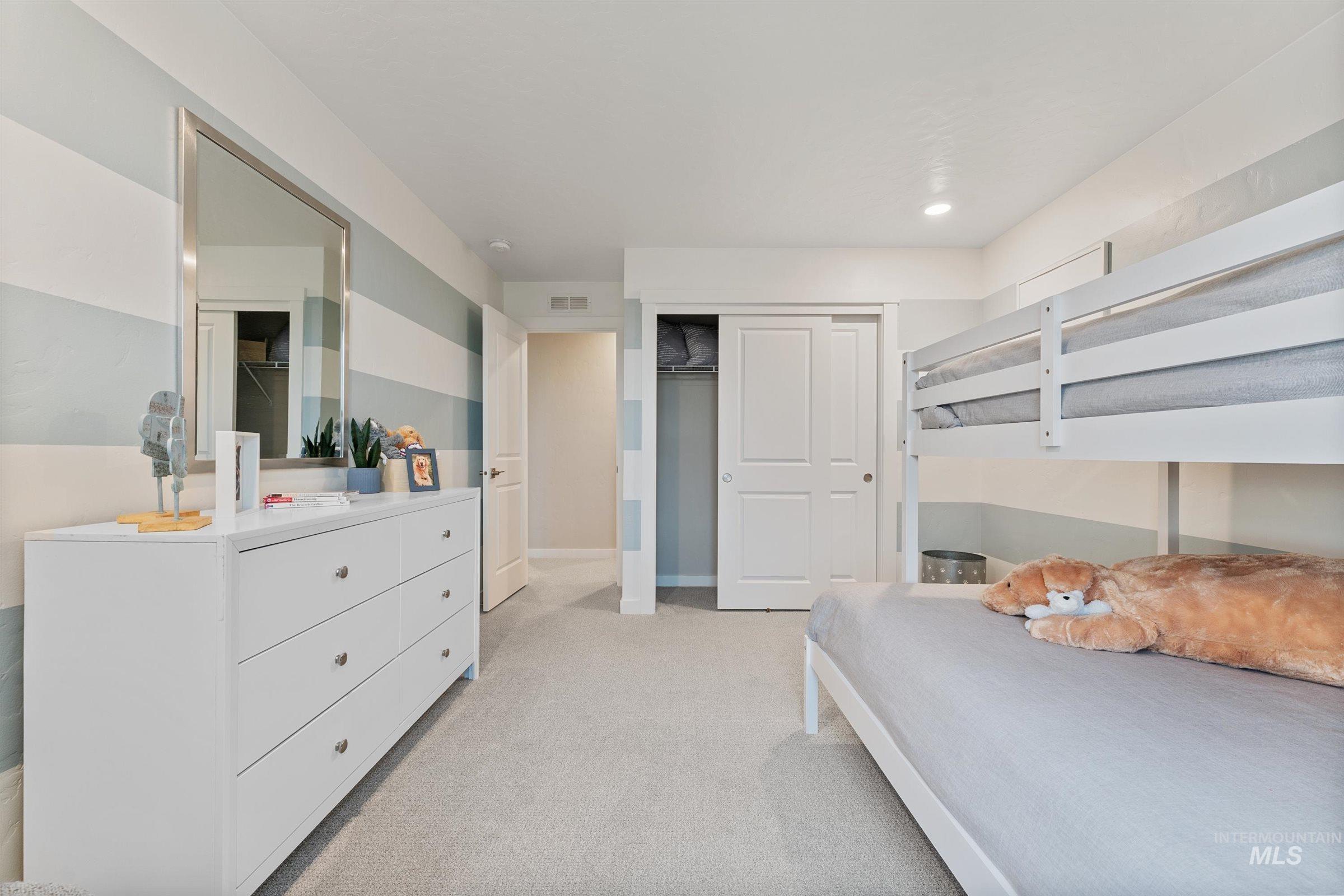 Bedroom featuring light colored carpet, a closet, and recessed lighting