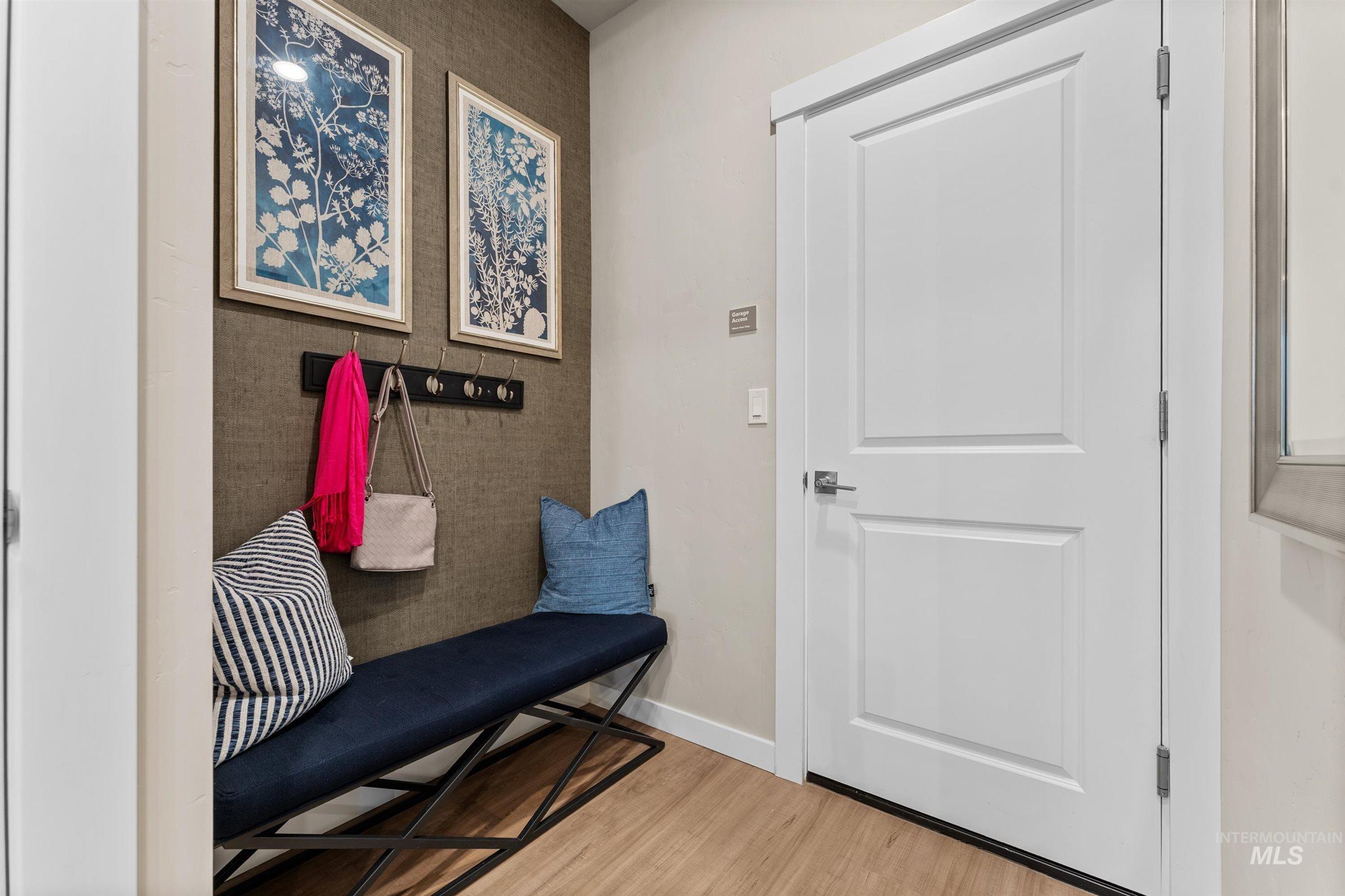 Mudroom featuring wood finished floors and baseboards
