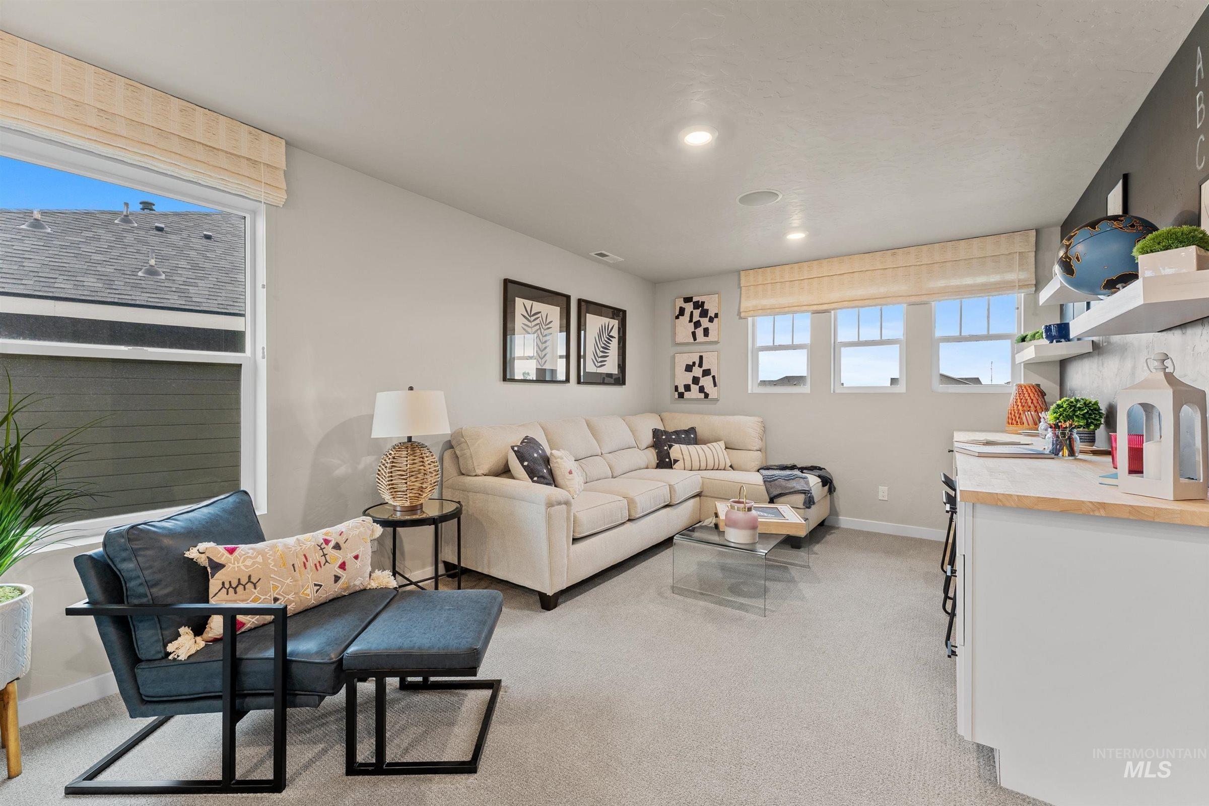 Living room featuring light colored carpet and baseboards