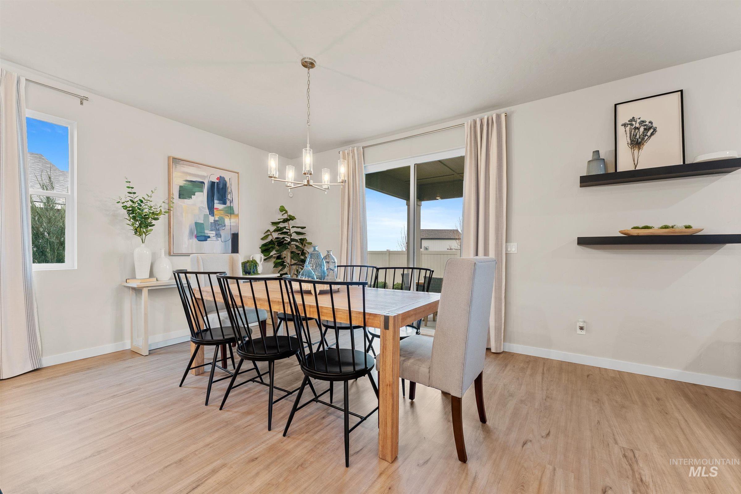 Dining area with light wood finished floors and a chandelier