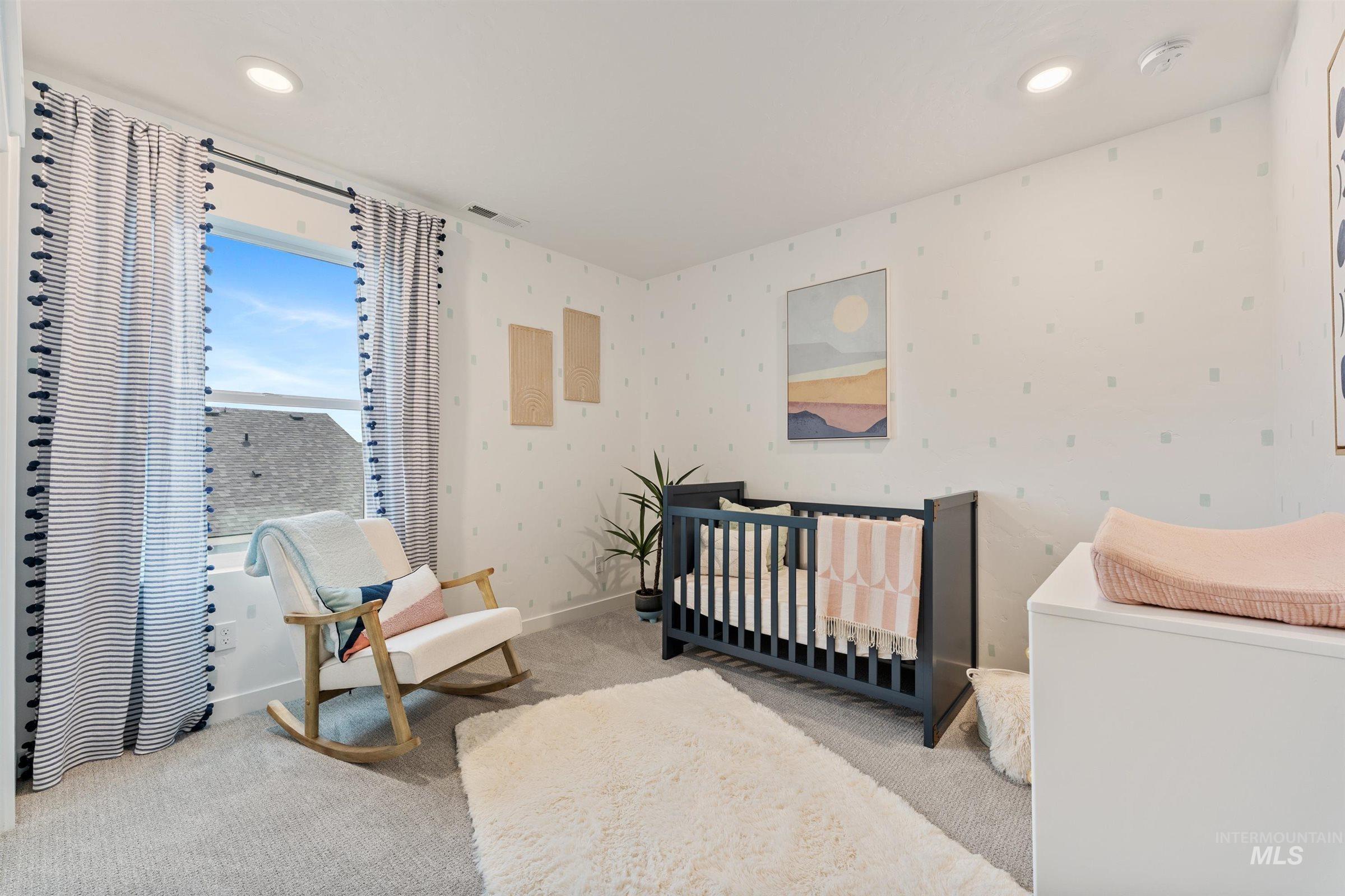 Bedroom featuring carpet flooring, a nursery area, recessed lighting, and wallpapered walls