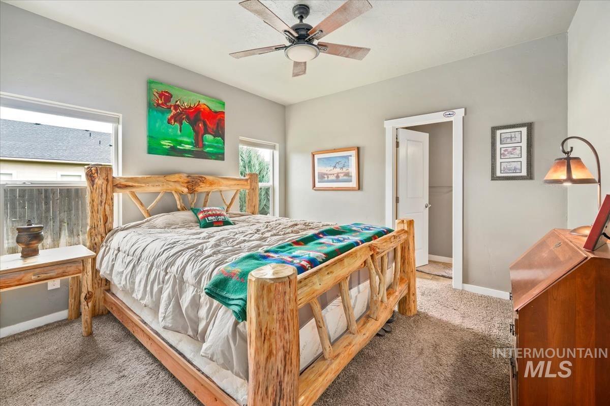 Bedroom featuring carpet and ceiling fan