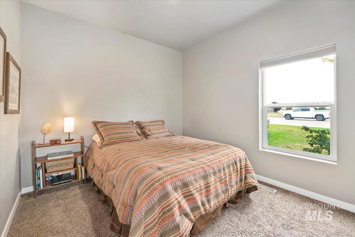 Carpeted bedroom with baseboards