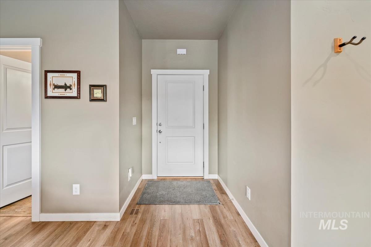 Foyer entrance featuring baseboards and light wood finished floors