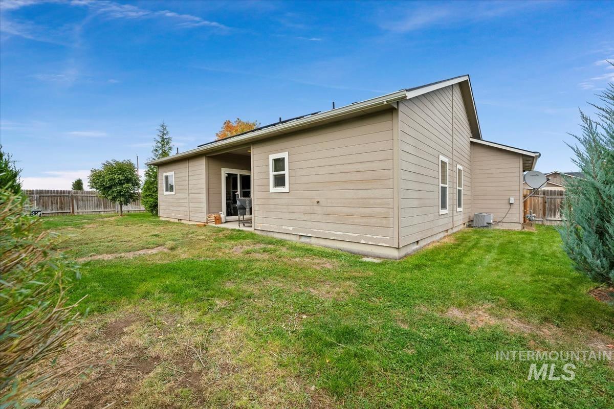 Rear view of house featuring a fenced backyard and a patio