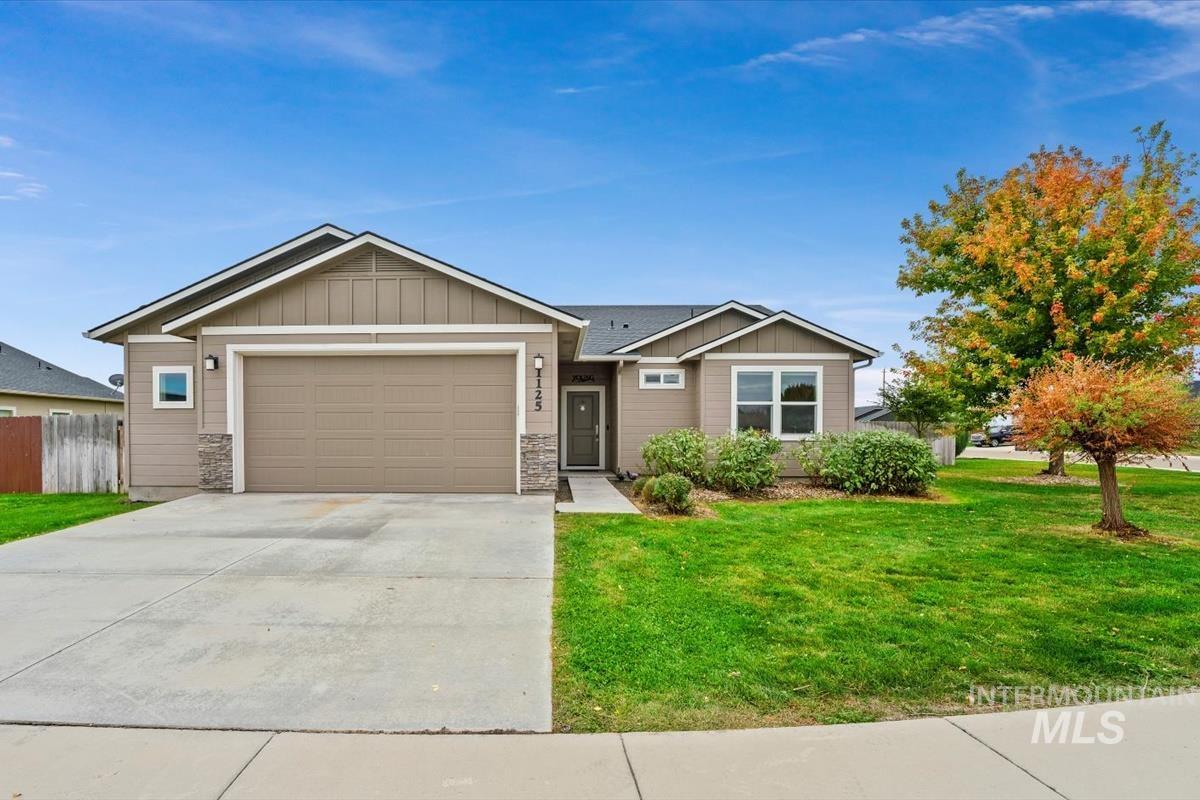 Craftsman house with board and batten siding, stone siding, concrete driveway, and a garage