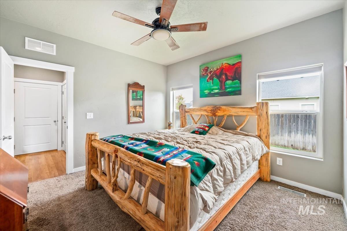 Bedroom featuring ceiling fan and carpet floors
